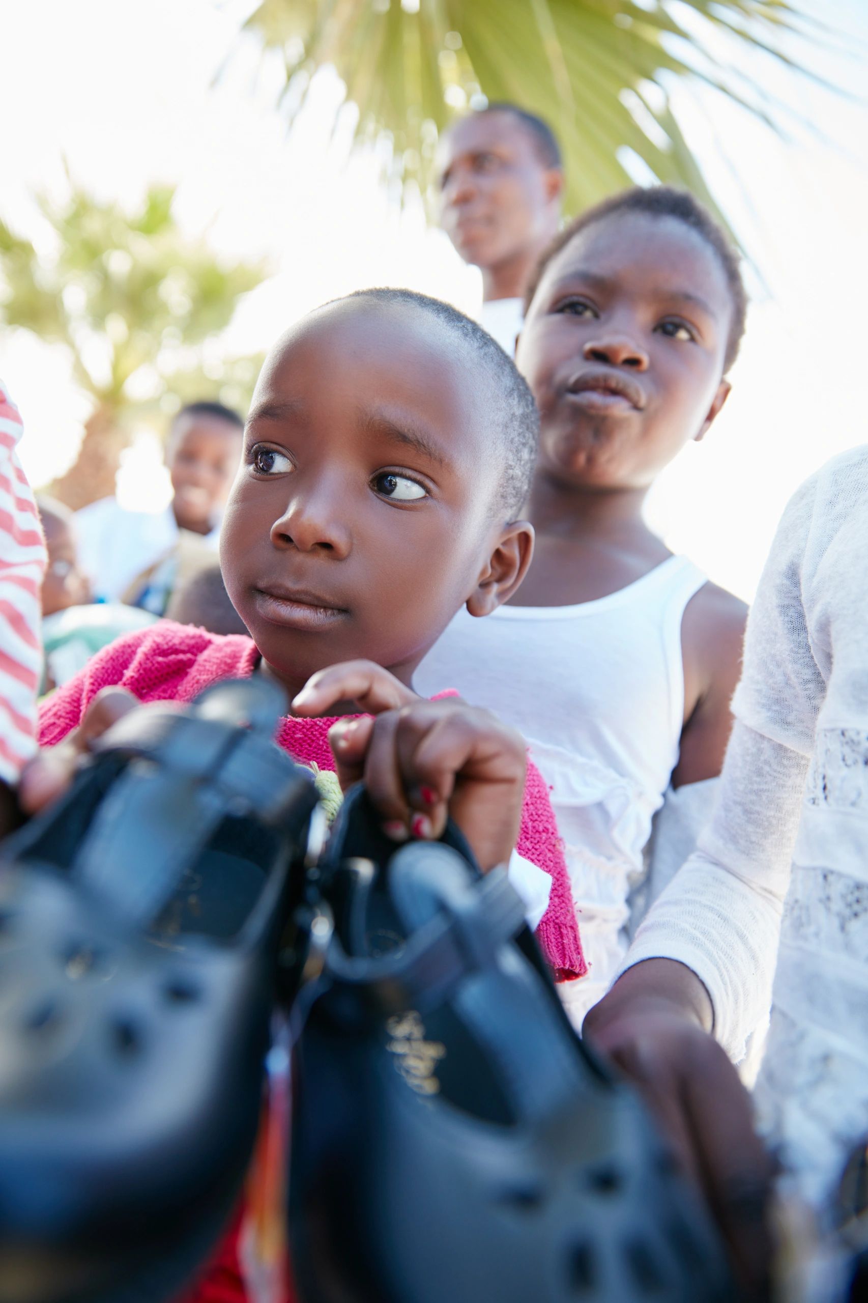 school children receiving shoes donation